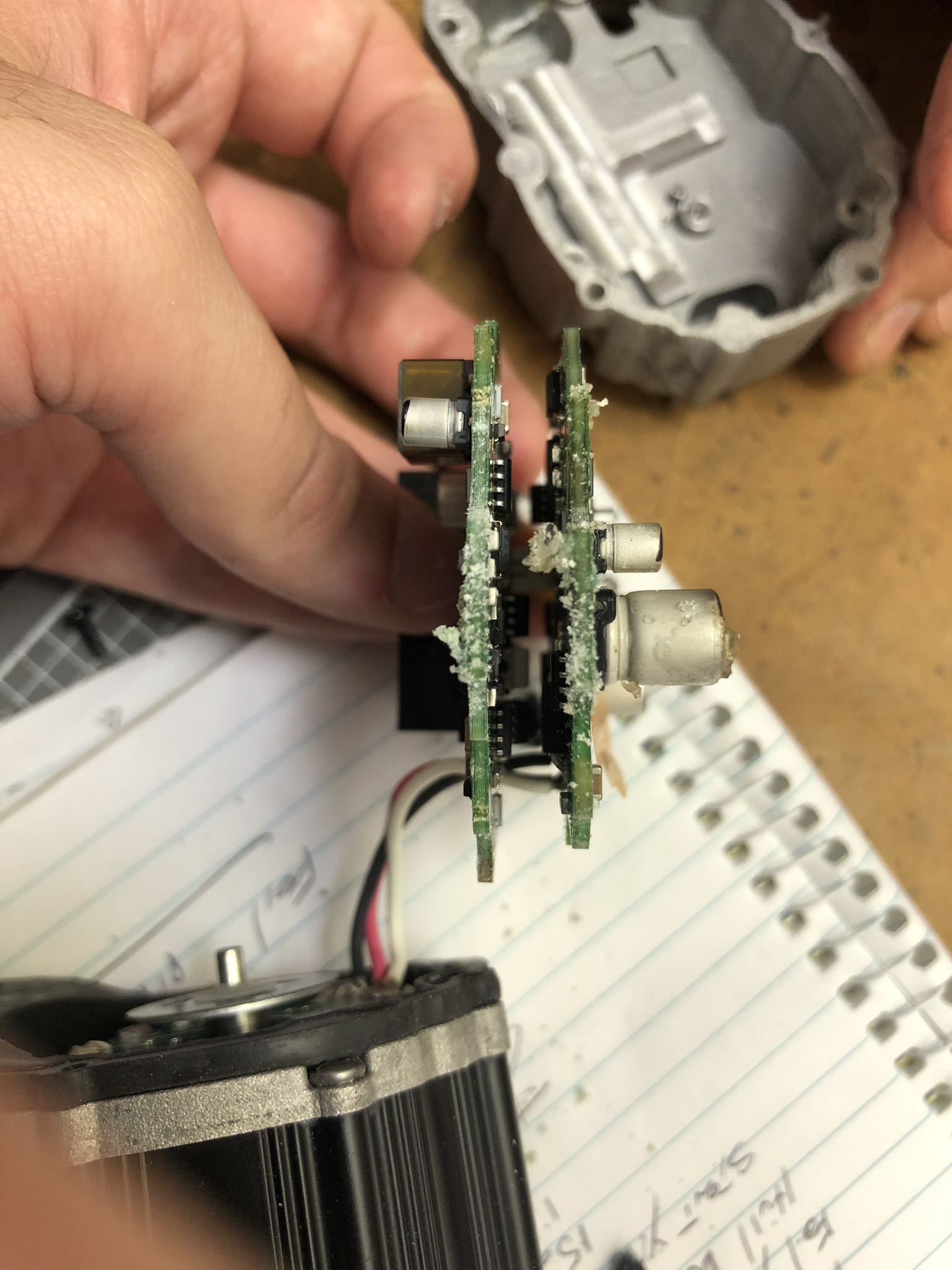 White corrosion/salts accumulated on bottom of both PCBs