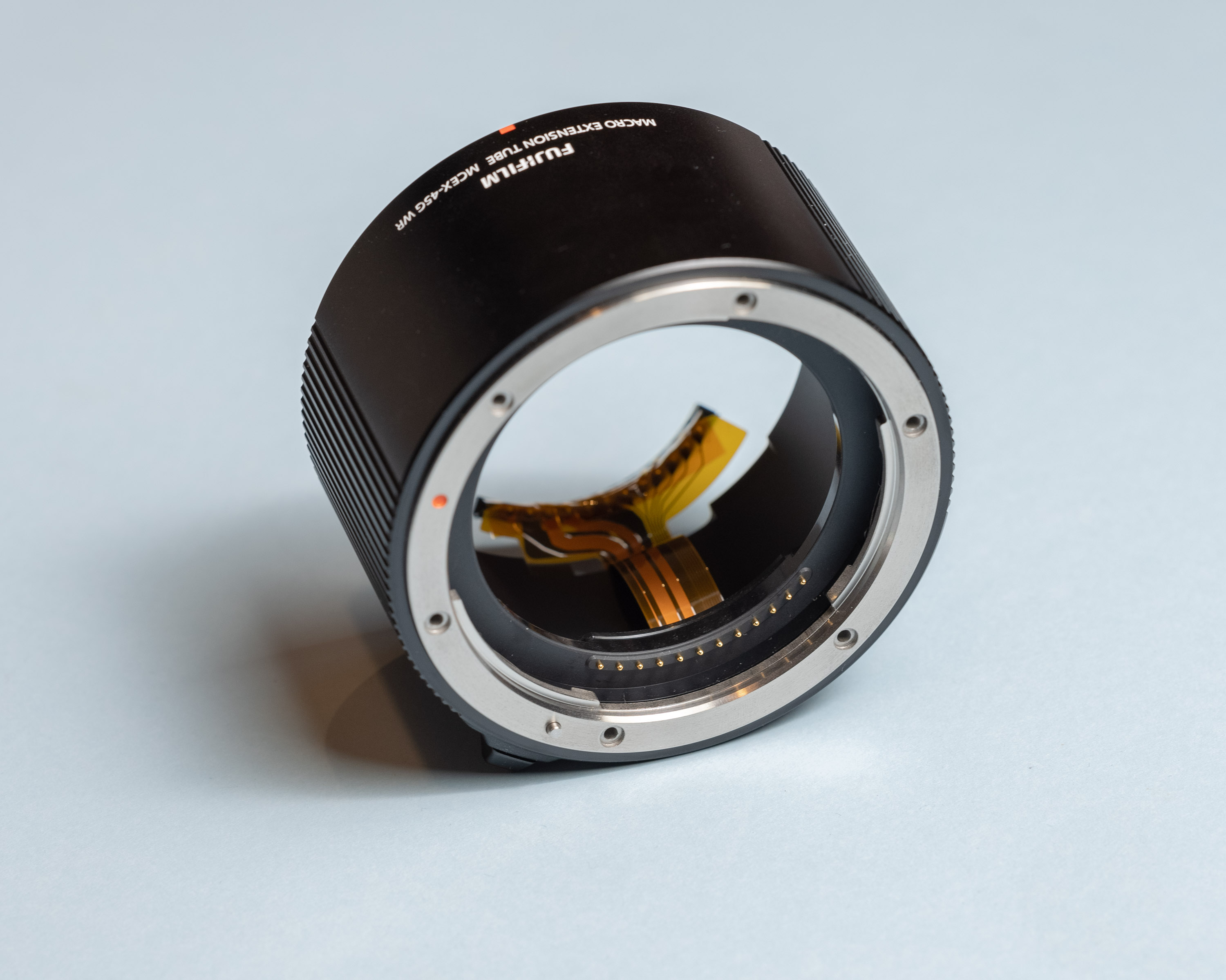 Angled view of extension tube and exposed flex PCB connecting to spring contacts